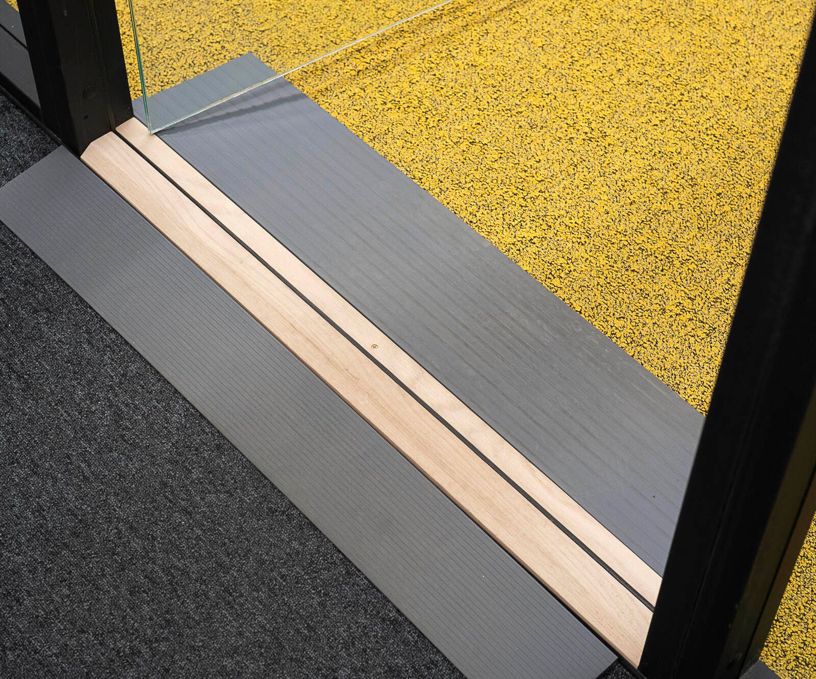 A close-up of a step under the entrance to an Octacell workroom
