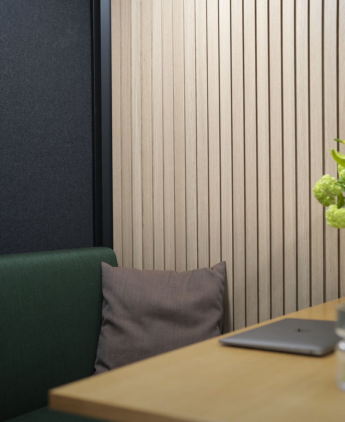 Interior of an Octacell Workroom with a desk, chair, and wooden wall panels.