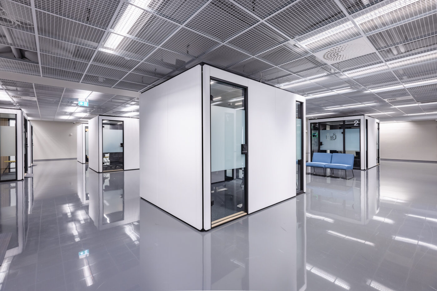 Octacell customer service workroom from the side with a secondary exit door