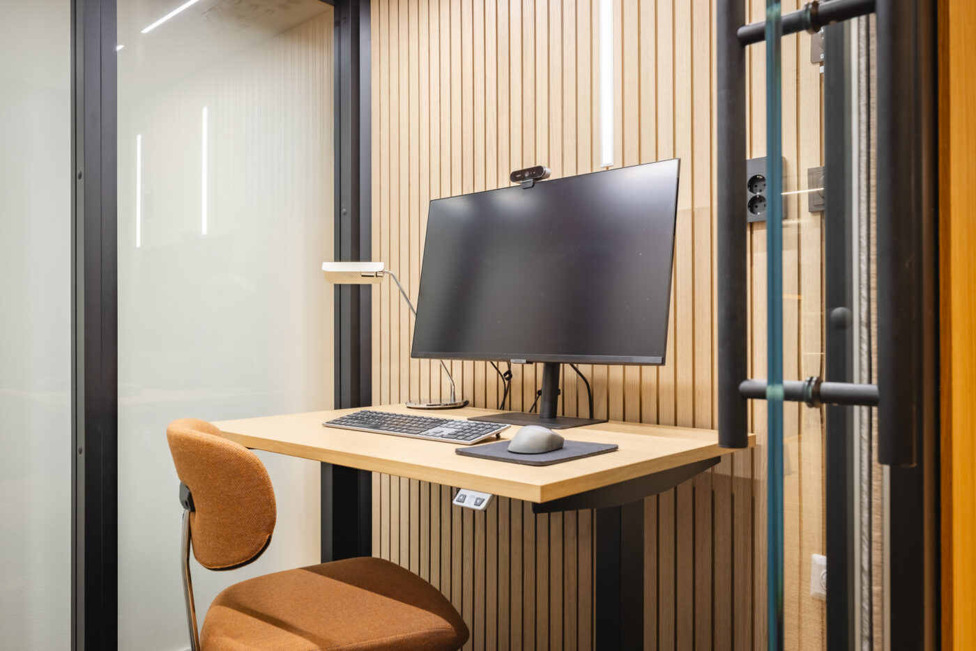 Octacell 2X2 workroom featuring a wooden desk, monitor and acoustic wall panels
