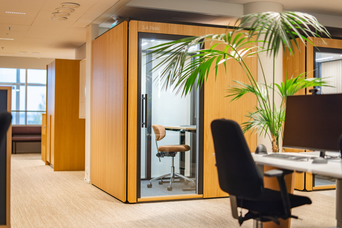 Octacell 2X2 workroom beside an office lounge area with plants and seating