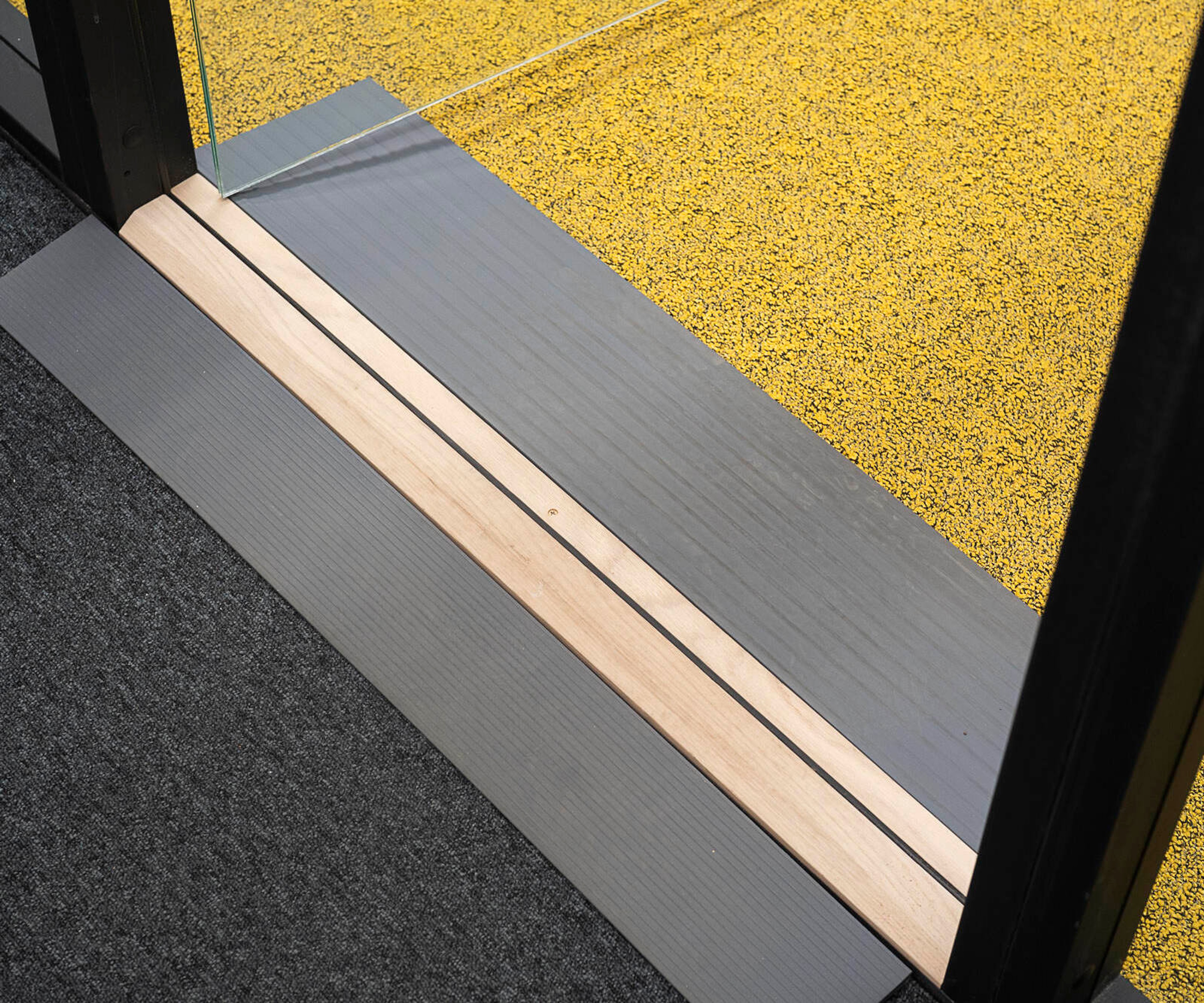 A close-up of a step under the entrance to an Octacell workroom