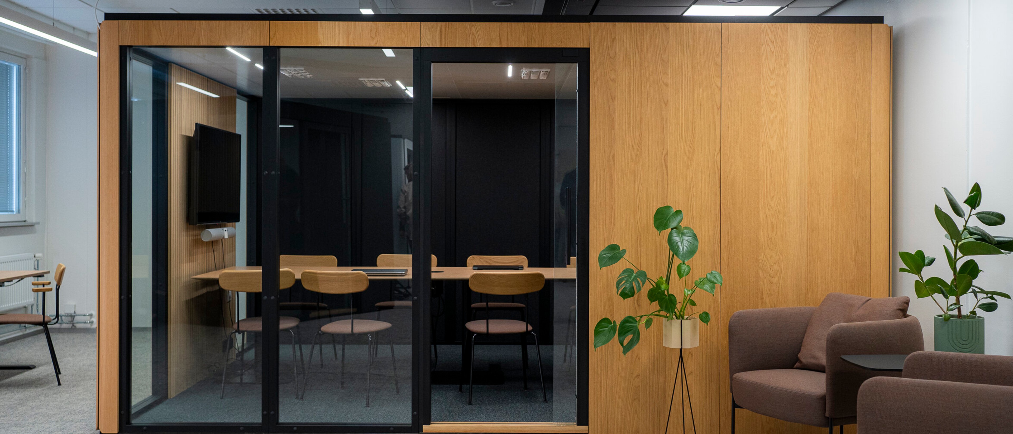 An empty, wood-paneled Octacell workroom in an office space