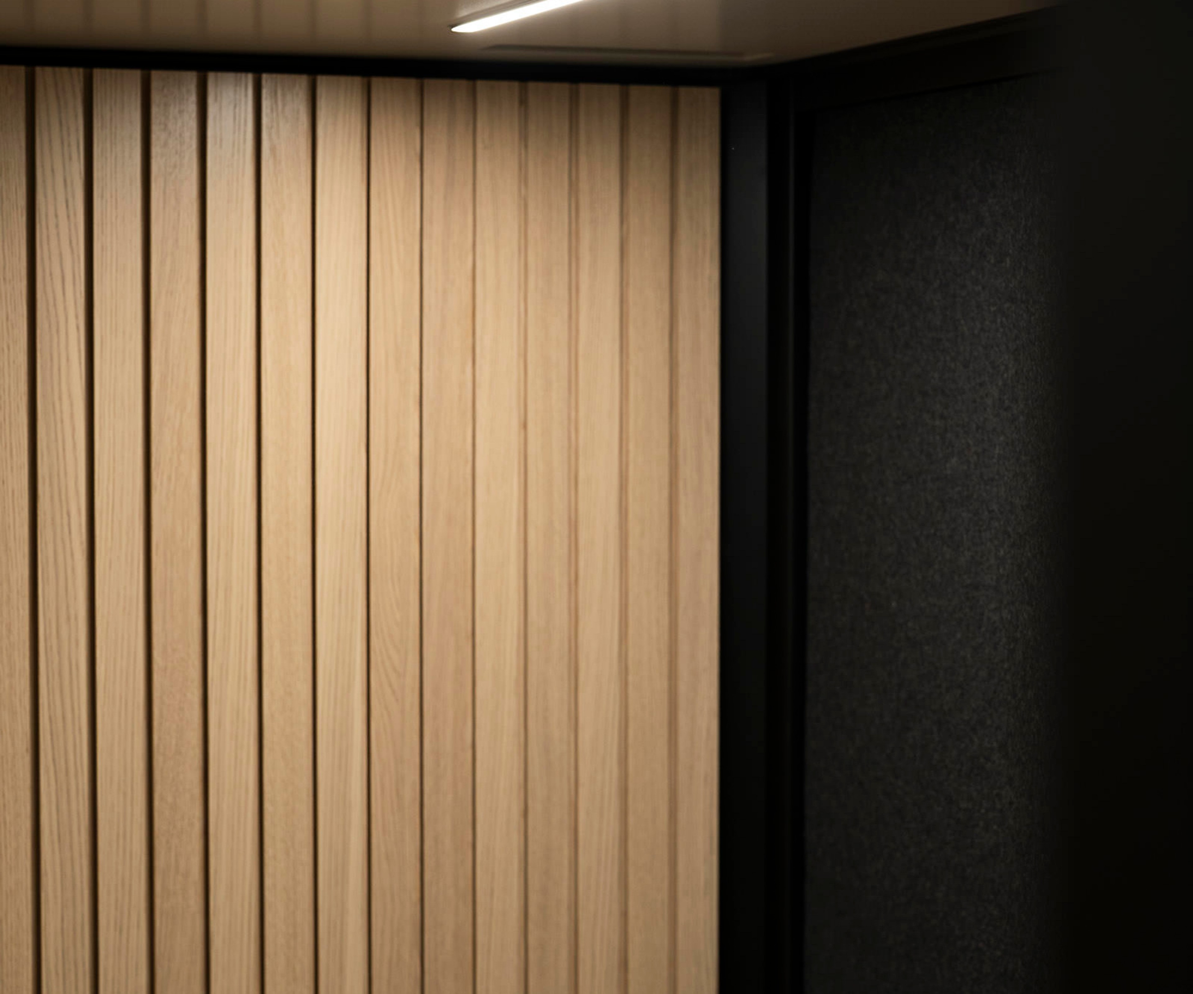 A close-up of the wood paneling in an Octacell workroom